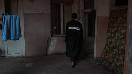 OAMC's black trench coat, available in 10 limited edition stores worldwide.