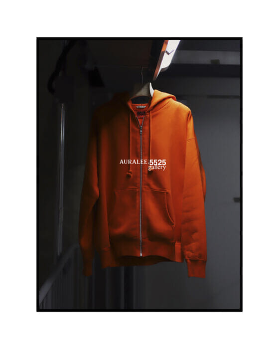 Chic orange hoodies!  It's the work of 5525 Gallery and Auralee.