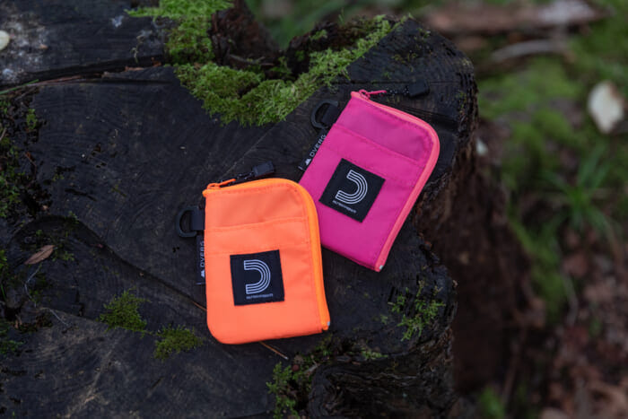 Dobelg and Half Track Products . The two popular garage brands collaborated to create a fluorescent compact wallet that looks great in the outdoor field.