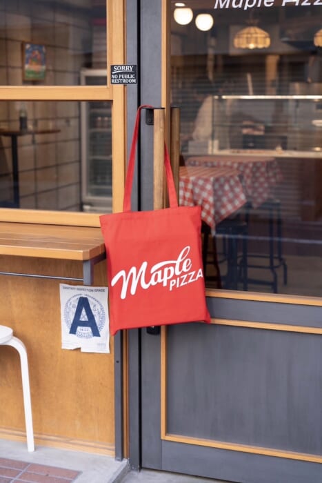 For downtown souvenirs, Maple Pizza caps, T-shirts, and tote bags are the way to go!